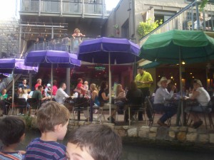 A view of the River Walk from a river cruise